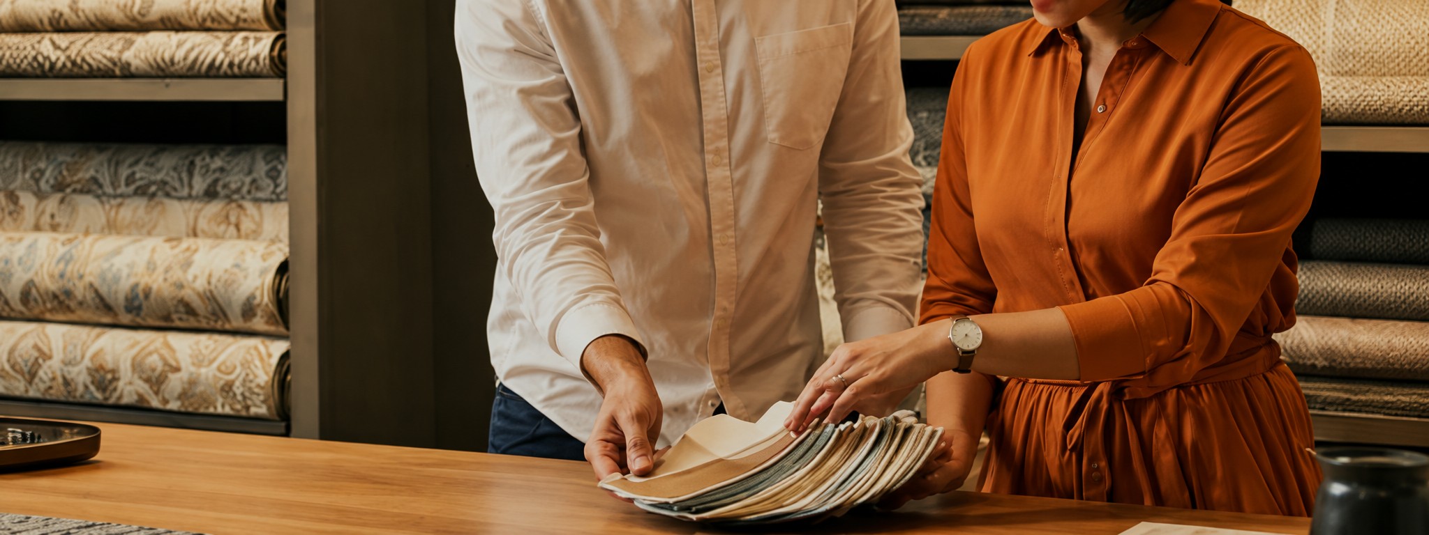 Couple selecting fabric swatches at a showroom table
